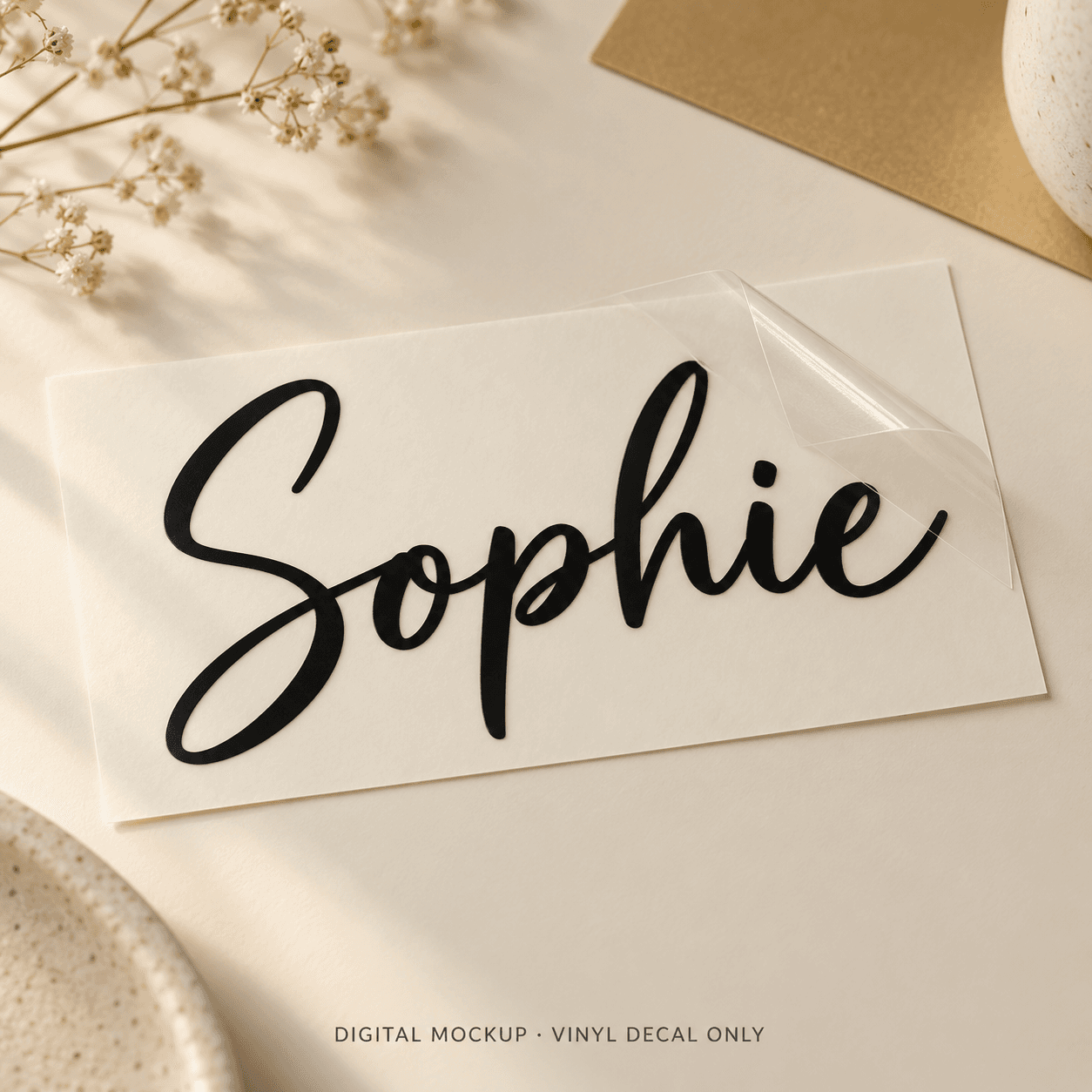 Digital mockup: Black script name "Sophie" on vinyl transfer backing. Vinyl decal only; props are not included.